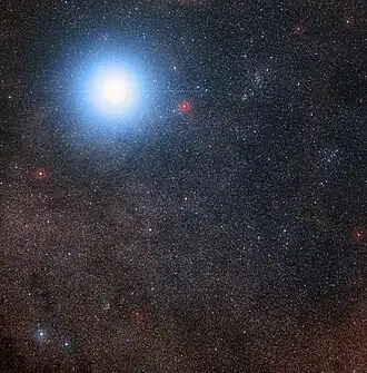One bright star against a dense background of fainter stars, with one of the fainter stars circled and annotated.