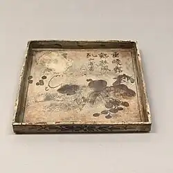 Square dish with grapes by Ogata Kenzan that was exhibited and later lost in the sinking of Le Nil on the way back to Japan and was recovered[10]