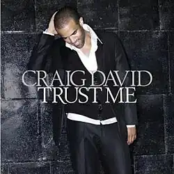 The cover features Craig David wearing a three-piece black suit, standing in front of a black block wall. Both the artist's name and the album title appear in front of him, colored in white.
