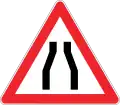Road narrows on both sides