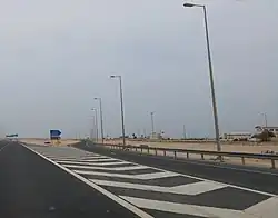 Turn off to Madinat Al Kaaban on Al Shamal Road