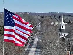 A U.S. flag waving above Montauk Highway