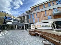 University campus buildings constructed of timber and concrete, outdoor staircases and new landscape and paving.