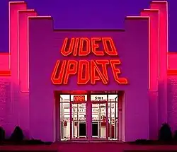 A one-story building with accented stepped accents flanking either side of the fascia. A red Video Update sign, showing the company logo—the angular letters Video Update in a perspective slant—is prominent on the facade.
