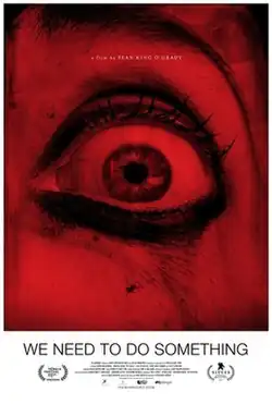 An enlarged image of a human eye under red light.