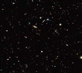 This image from the NASA/ESA/CSA James Webb Space Telescope shows an arrangement of ten galaxies. The 3-million-light-year-long filament is anchored by a quasar.