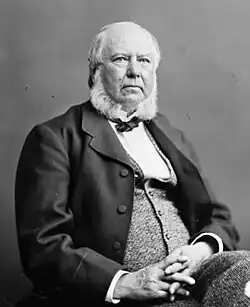 Portrait photograph of William Johnstone Ritchie sitting and facing right in 1880.