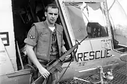 A1C William Pitsenbarger in front of an HH-43 Huskie