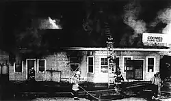 A small wooden building on fire