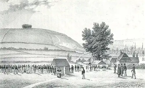 Engraving of St. Catherine's Hill as a bare hill in 1838, with a Winchester College football match, by then played in the Itchen valley rather than on the hilltop[7]