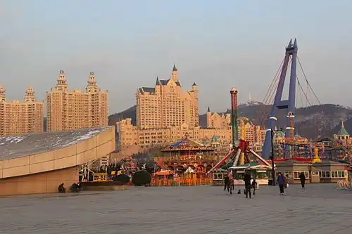 Xinghai Square amusement park with the Castle Hotel in the background