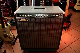 A wooden speaker cabinet with an integrated amplifier.