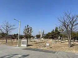 Trees, a statue, and footpaths in the park (2023)